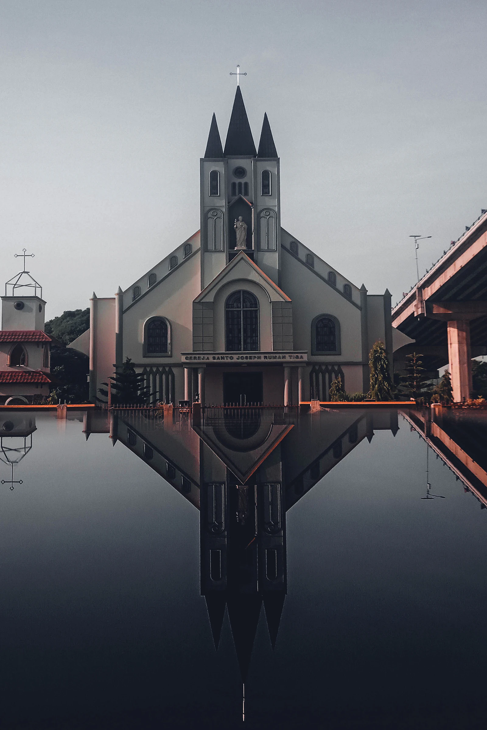 Church facade reflected in still water