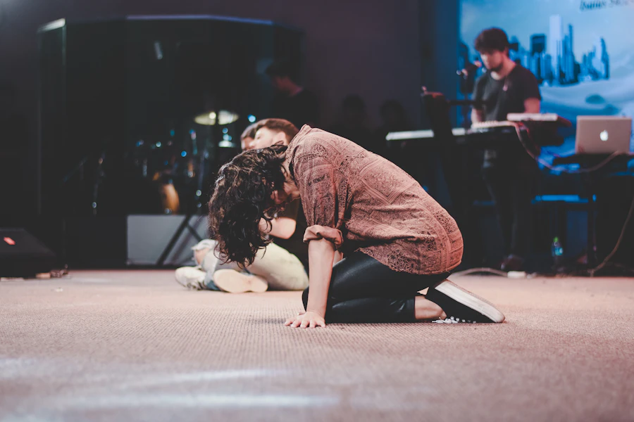 Minister kneeling in prayer during a worship service